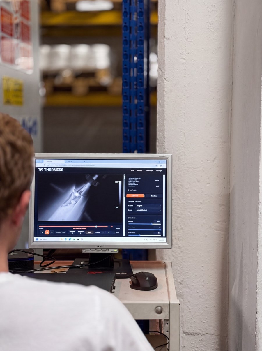 Operator looking at the HeatCore live thermal view of a weld on a workshop screen