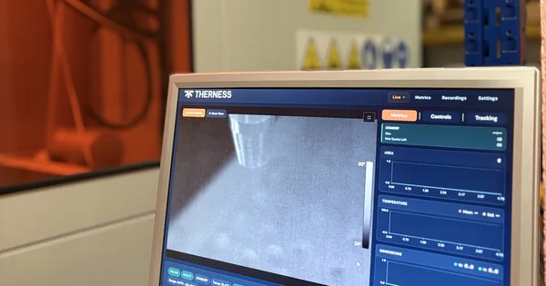 Therness lab welding cell with HeatCore live weld monitoring on the screen beside the cell